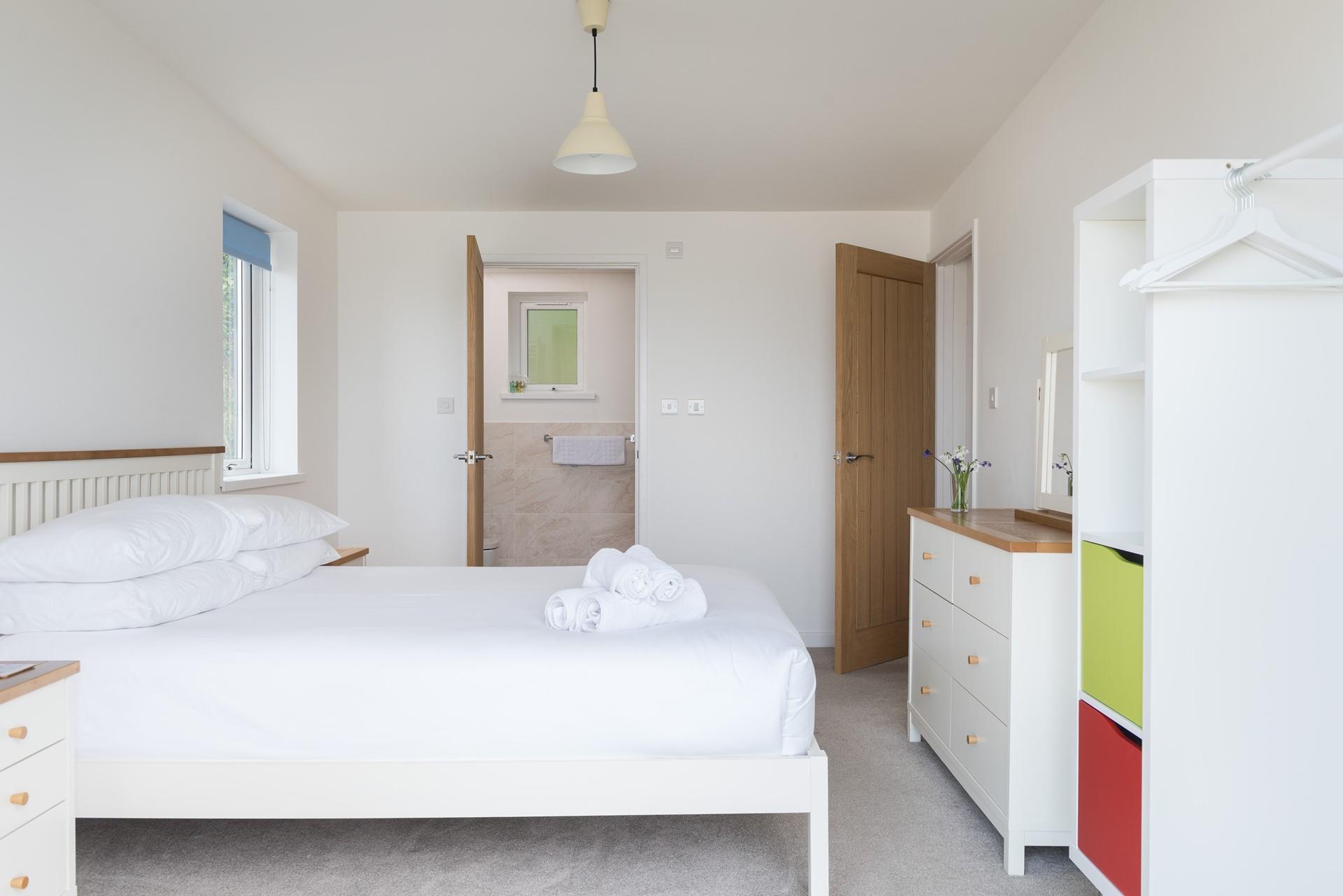 Bedroom 1 benefits from ample storage space and an ensuite shower room. 