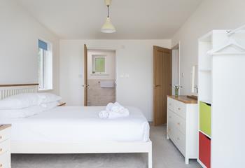 Bedroom 1 benefits from ample storage space and an ensuite shower room. 