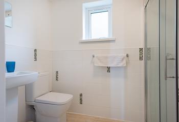 The main shower room is bright and spacious with an enclosed shower. 
