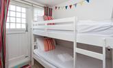 Tuck the kids into the bunk beds after a memorable beach day. - Thumbnail Image