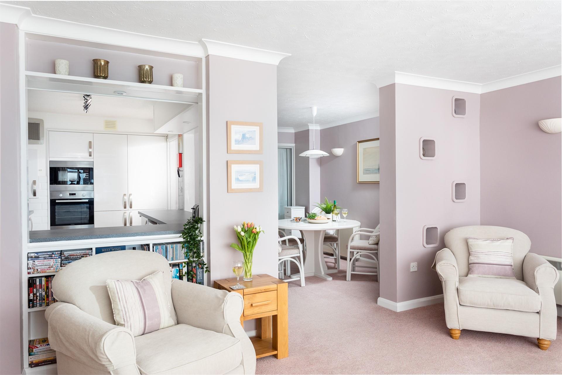 Calming pastel tones and plenty of natural light create a relaxing living area. 