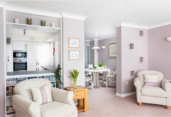 Calming pastel tones and plenty of natural light create a relaxing living area. 