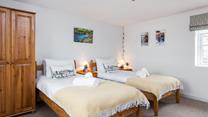 Tuck the kids into bed in the twin room after a memorable day on the beach.