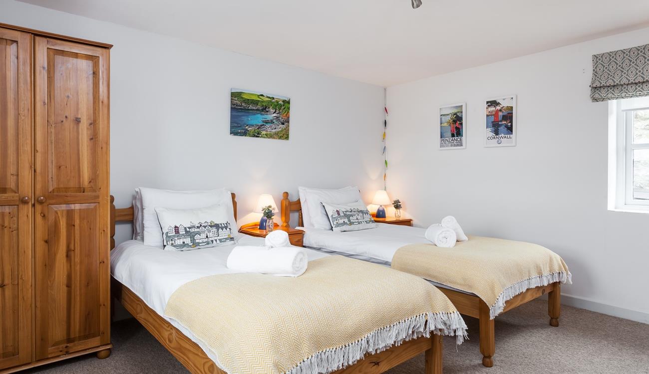 Tuck the kids into bed in the twin room after a memorable day on the beach.