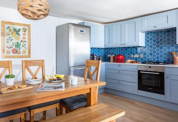 The kitchen is well-equipped with an ocean blue theme.