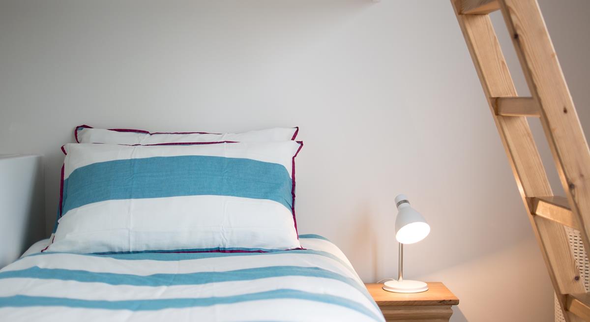 Children will love this cosy bed with ladder leading up to the top bunk. 