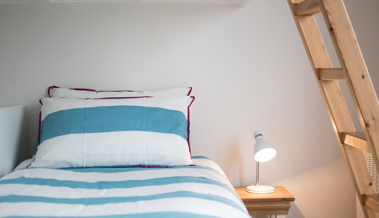 Children will love this cosy bed with ladder leading up to the top bunk. 