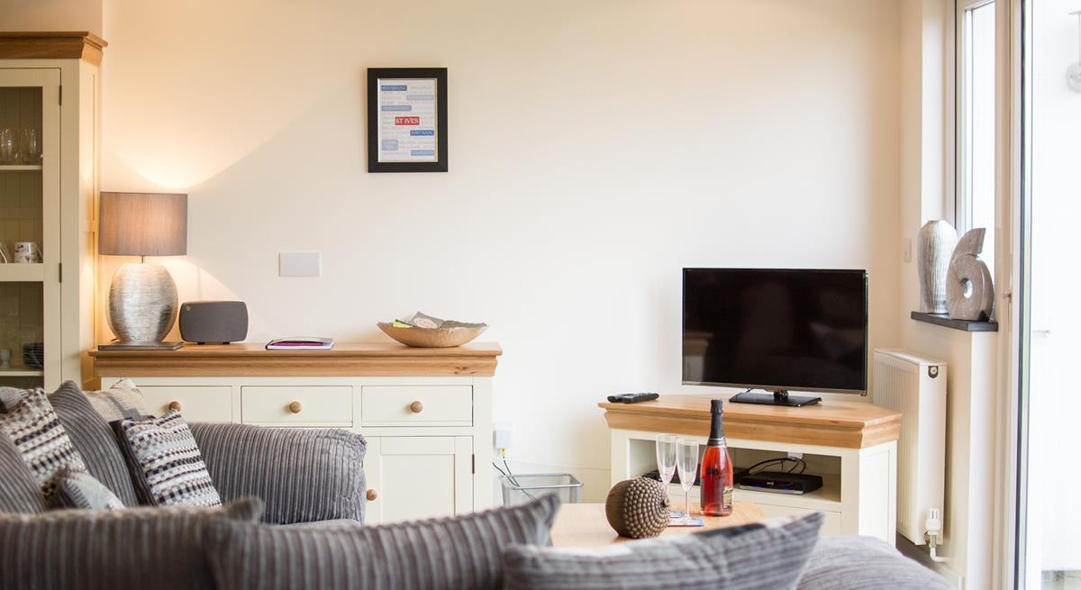 Sink into the sumptuous sofa for a relaxing evening; on warmer days open up the patio doors and let the evening air float in. 