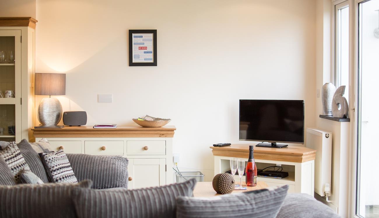 Sink into the sumptuous sofa for a relaxing evening; on warmer days open up the patio doors and let the evening air float in. 