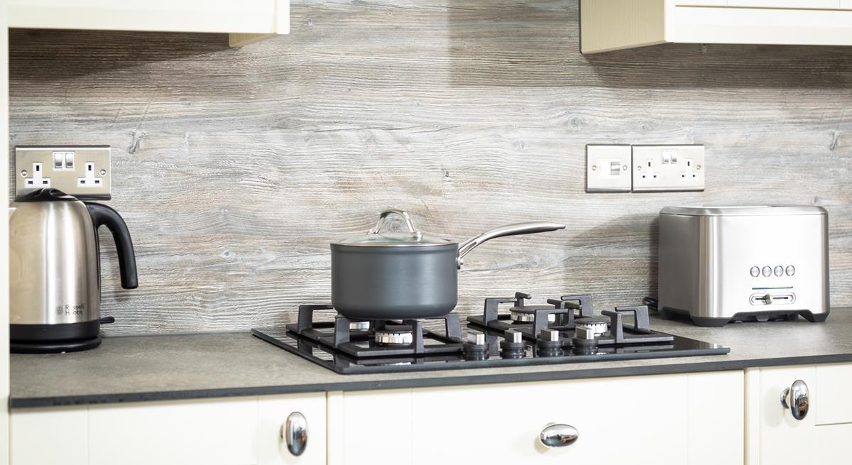 The kitchen is well-equipped with all the essentials for your stay at Garth Cottage. 