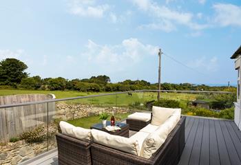 Relax on the large balcony, glass of wine in hand, overlooking the meadows and distant sea views. 