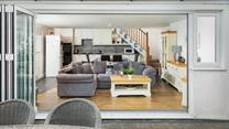 The open plan living area benefits from bi-fold doors that open onto the private patio and garden. 