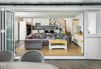 The open plan living area benefits from bi-fold doors that open onto the private patio and garden. 