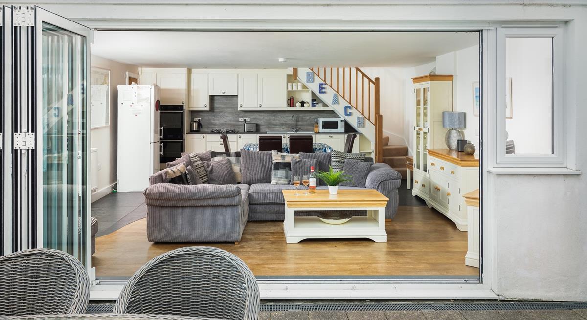 The open plan living area benefits from bi-fold doors that open onto the private patio and garden. 