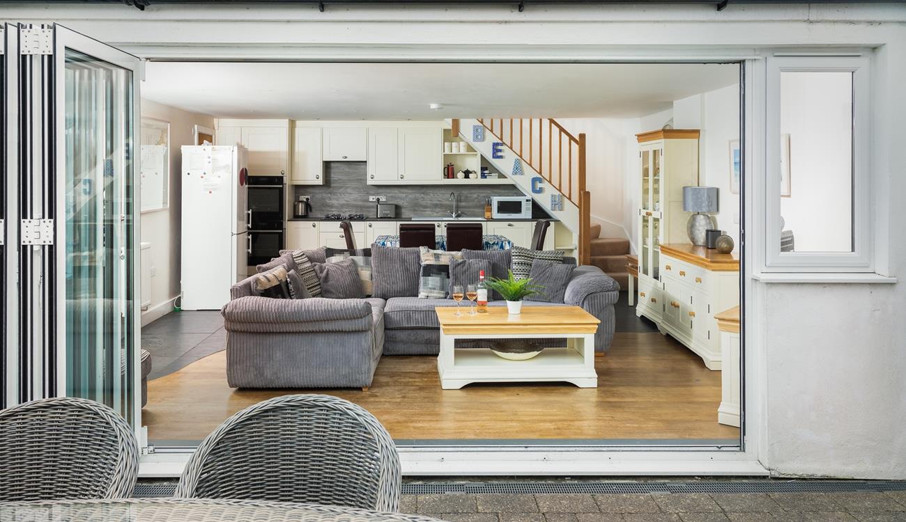 The open plan living area benefits from bi-fold doors that open onto the private patio and garden. 