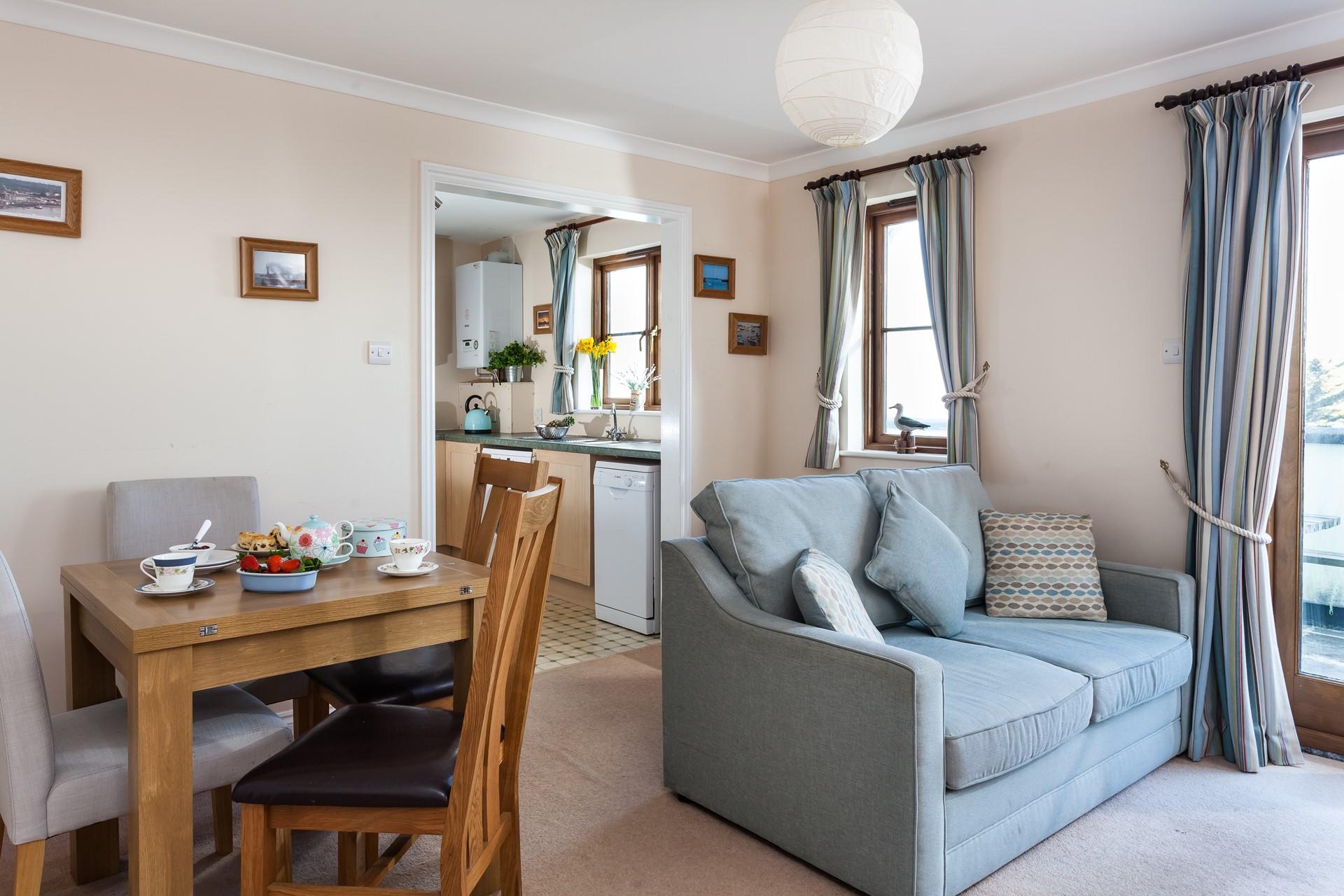 The light and airy living area is a cosy retreat after a day exploring the coast.