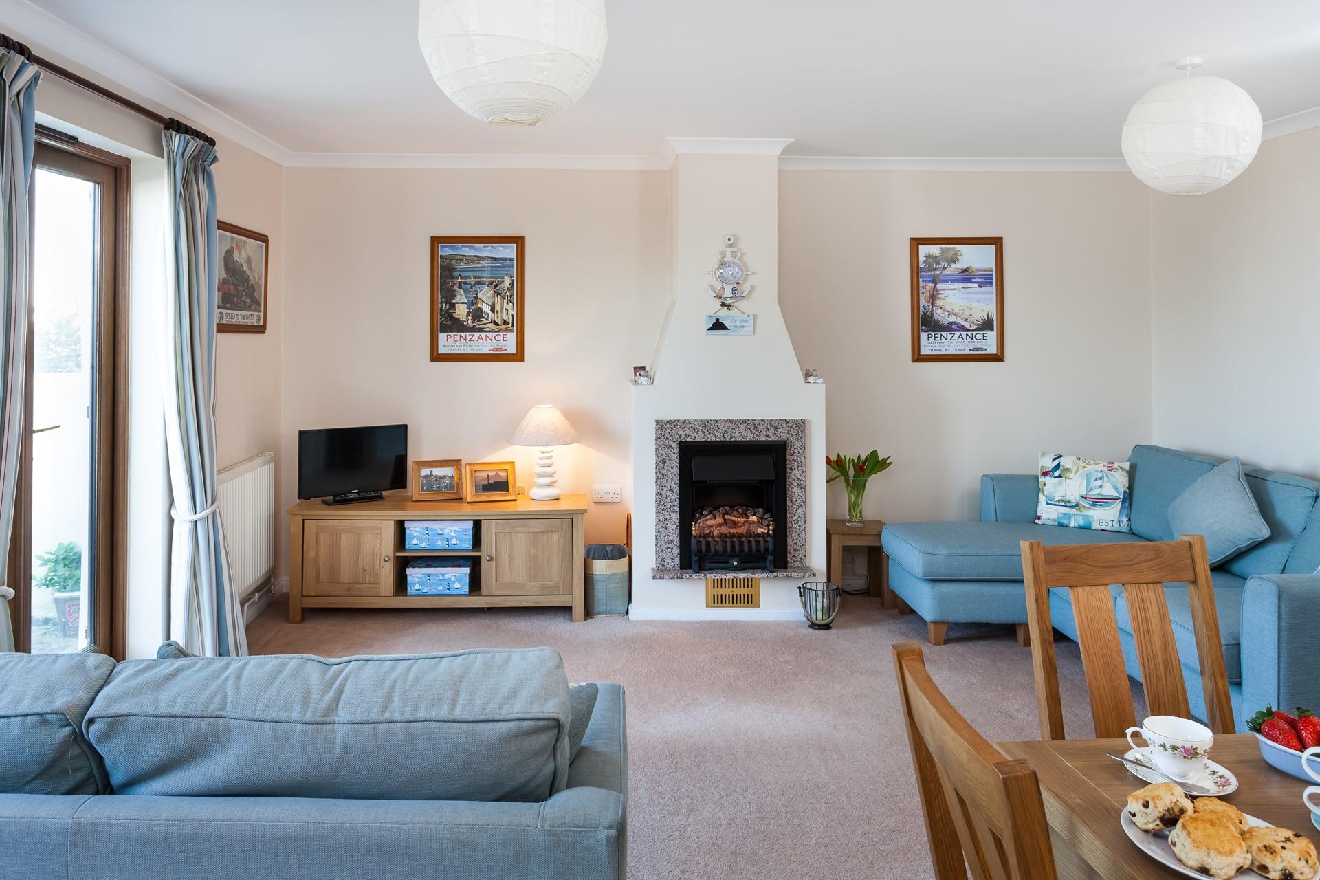 The open plan sitting/dining kitchen area is comfortably furnished with plenty of seating for four. 