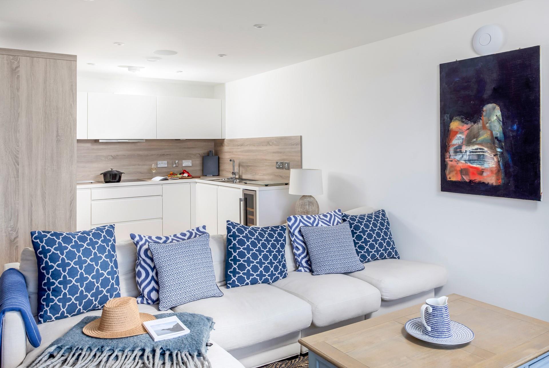 Cool, coastal blues and sumptuous soft furnishings adorn the living area.