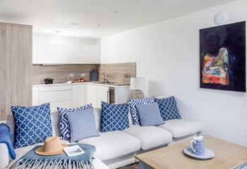 Cool, coastal blues and sumptuous soft furnishings adorn the living area.
