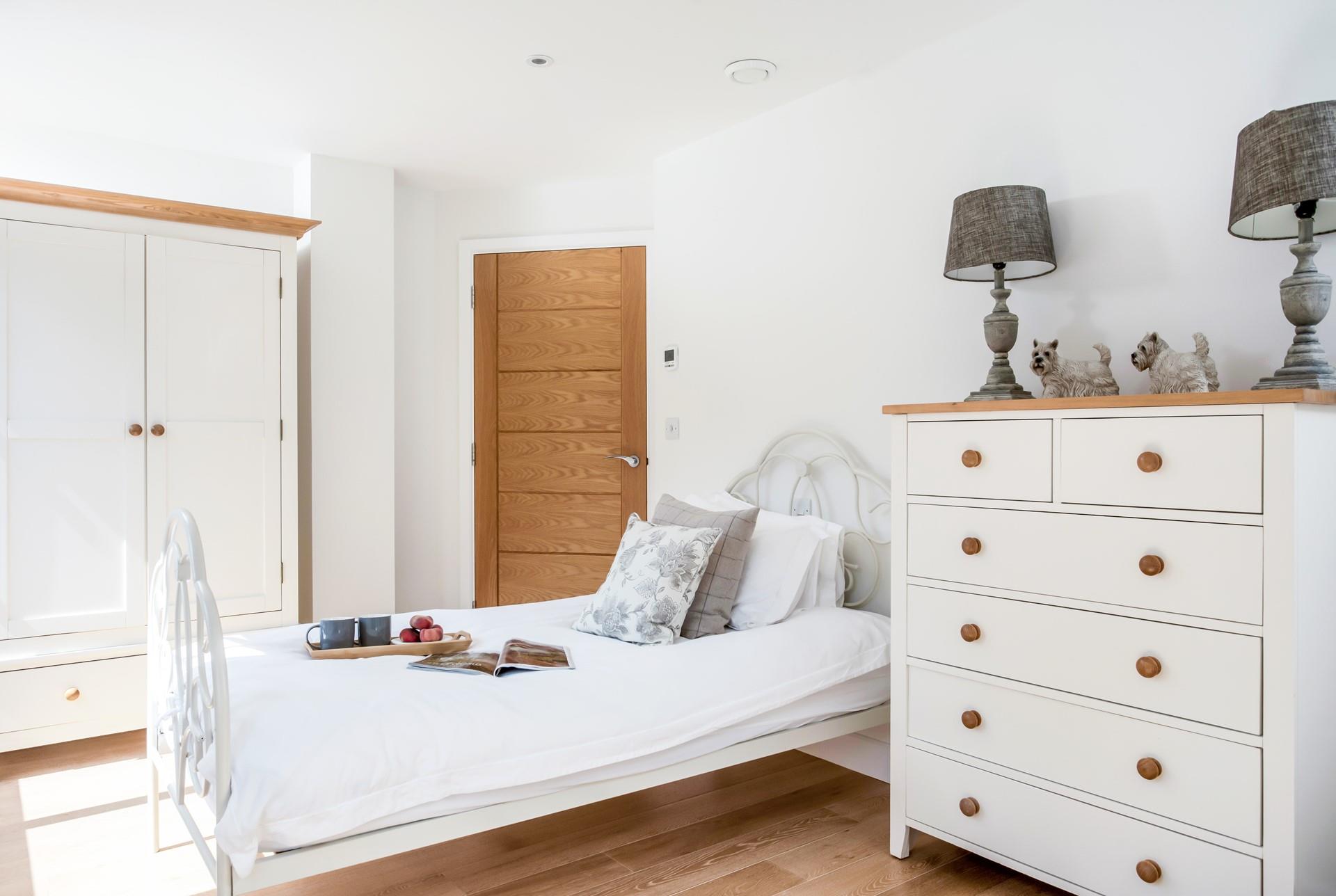 The twin bedroom features lovely furniture for unpacking your beach clothes.