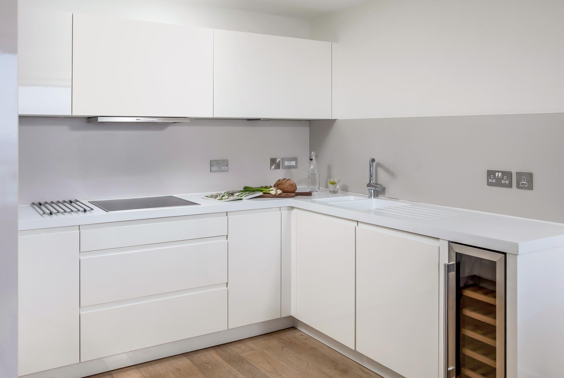 The sleek modern kitchen is perfectly equipped to rustle up delicious meals.