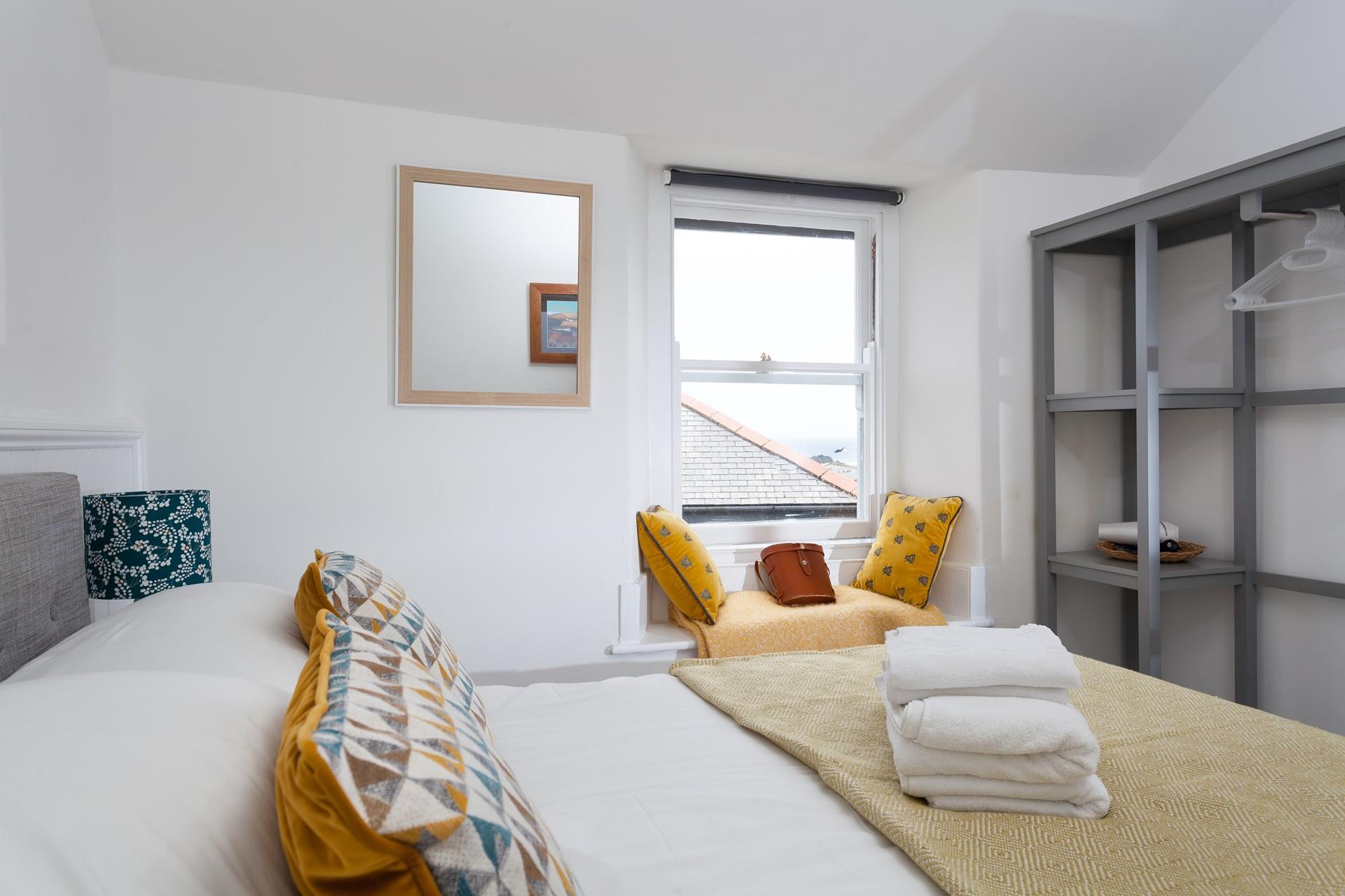 Relax in bed after a day of exploring Cornwall's coastline.