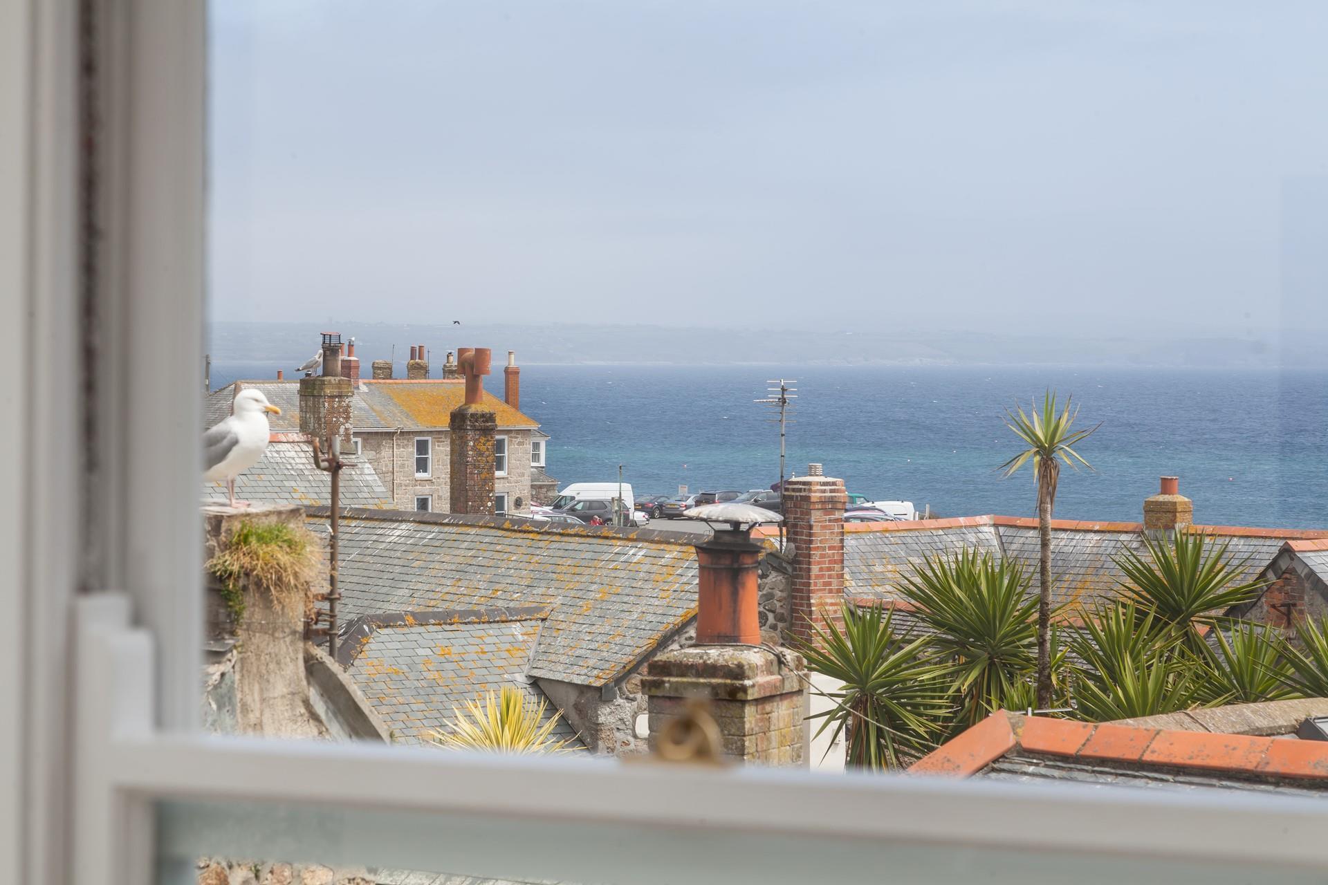 Views over Mousehole across Mounts Bay towards the Lizard Peninsular.