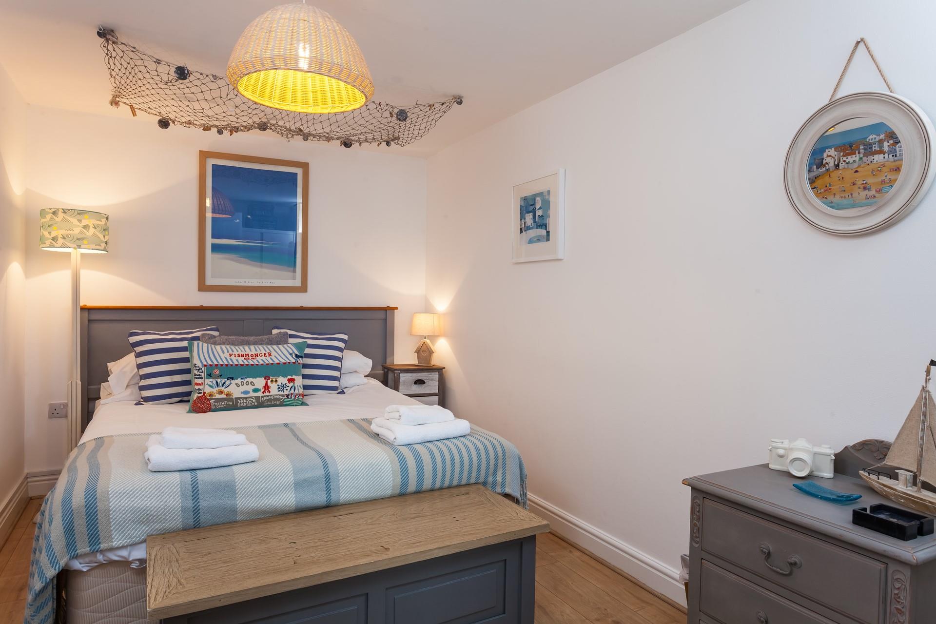 Snuggle up in the seaside-inspired bedroom and drift off to the distant sound of the sea. 