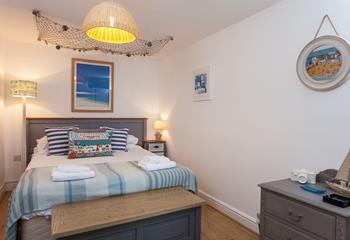 Snuggle up in the seaside-inspired bedroom and drift off to the distant sound of the sea. 