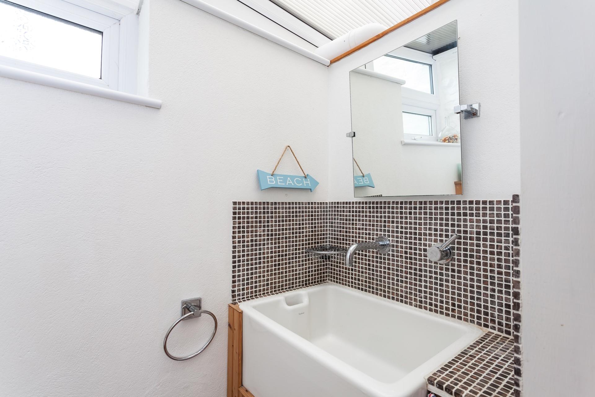 A downstairs cloakroom has a WC and basin. 