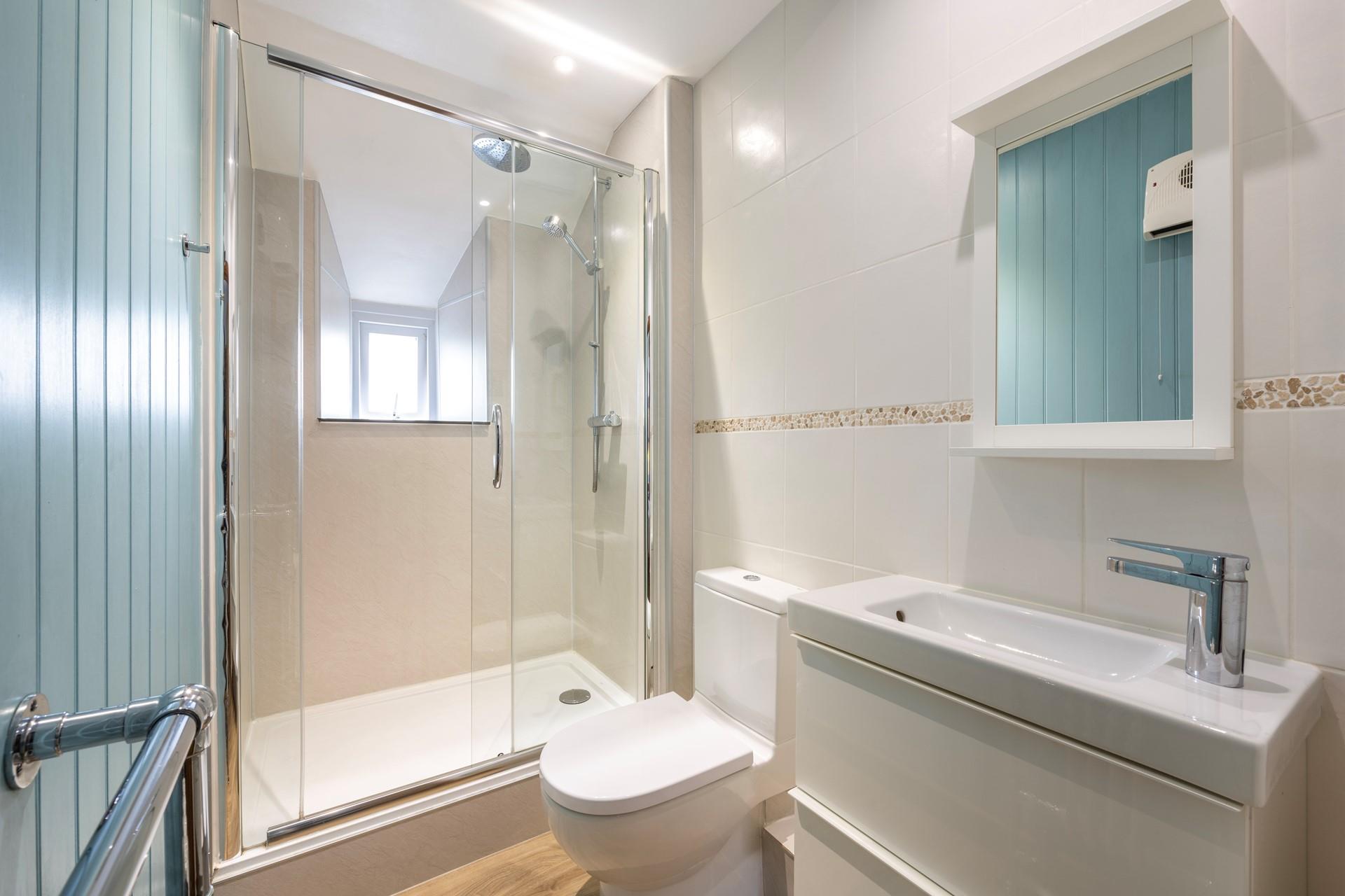 The double bedroom has an en-suite with a large enclosed shower, WC and basin. 