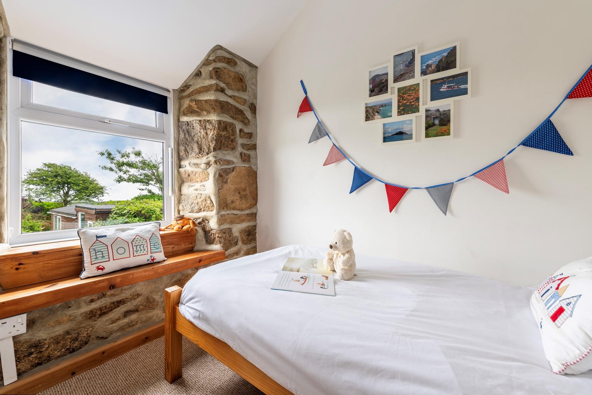 The single bedroom has a gorgeous exposed stone feature wall.
