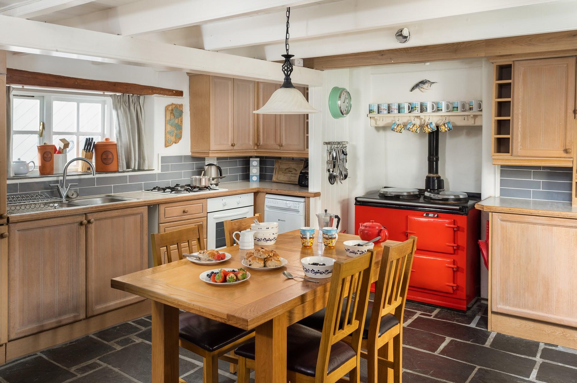 The kitchen with its bright aga has a homely feel that invites you to relax and make yourself at home.