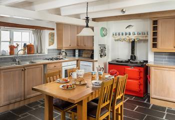 The kitchen with its bright aga has a homely feel that invites you to relax and make yourself at home.