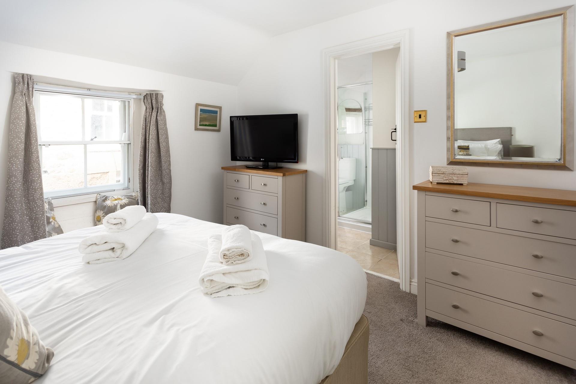 Bedroom 1 benefits from an en suite, providing extra space and privacy to get ready.