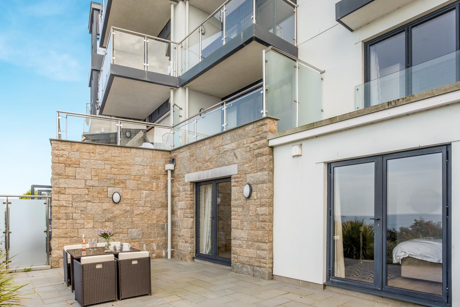 Step from the living area or the bedroom onto the sea-facing patio.
