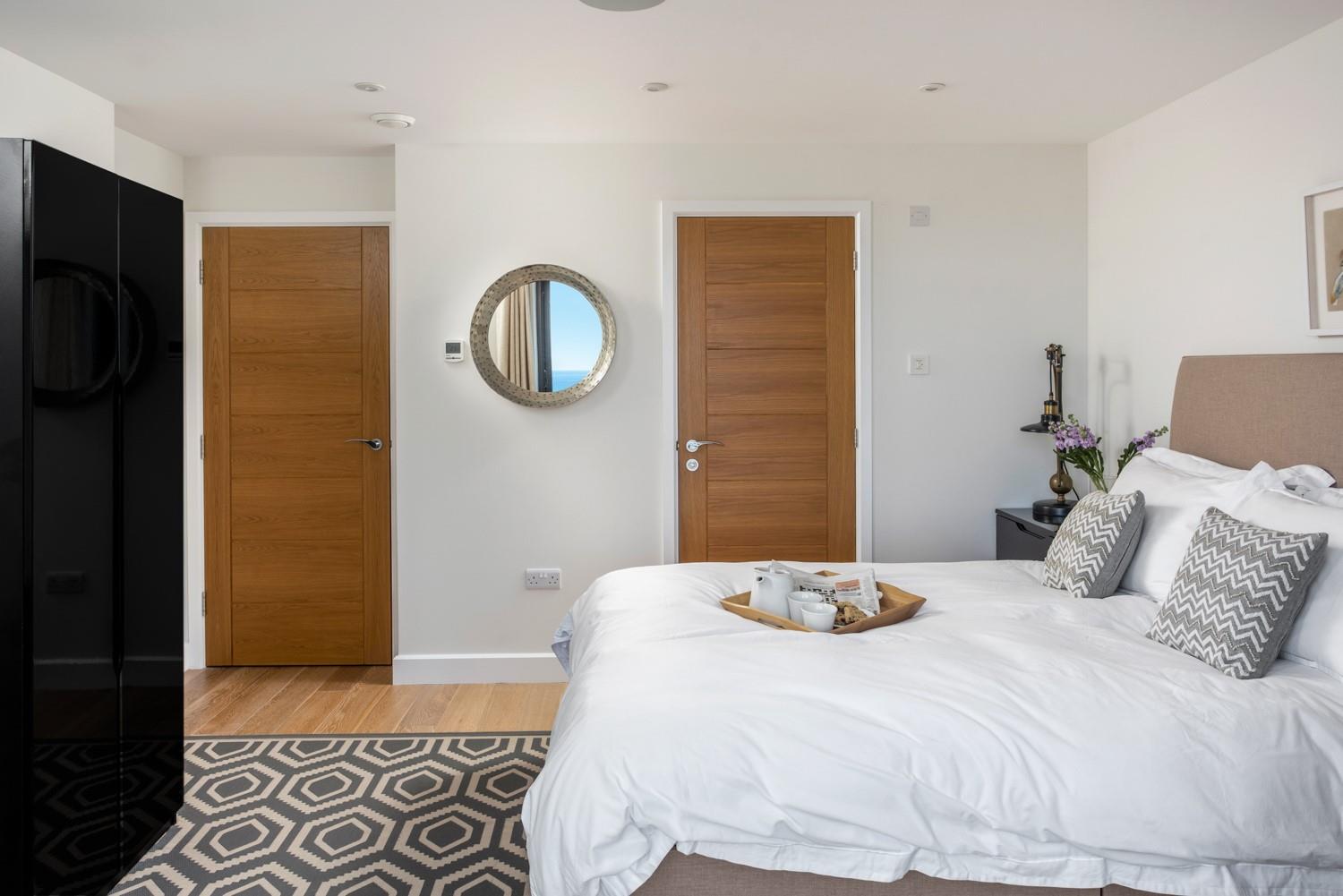 The master bedroom has a handy en suite as well as those beautiful sea views.
