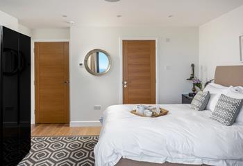 The master bedroom has a handy en suite as well as those beautiful sea views.