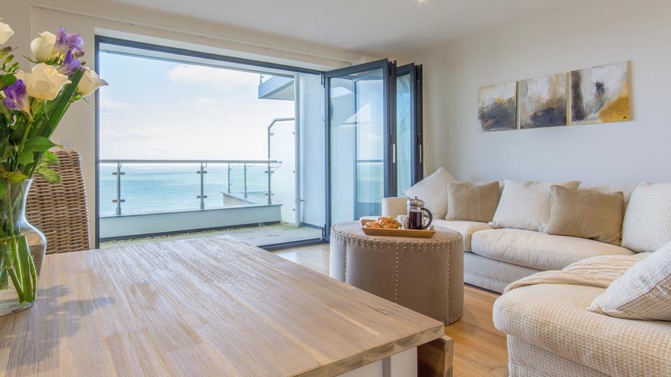 The living space has a stunning view across Porthminster from the bi-fold doors out onto the glass balustrade balcony.