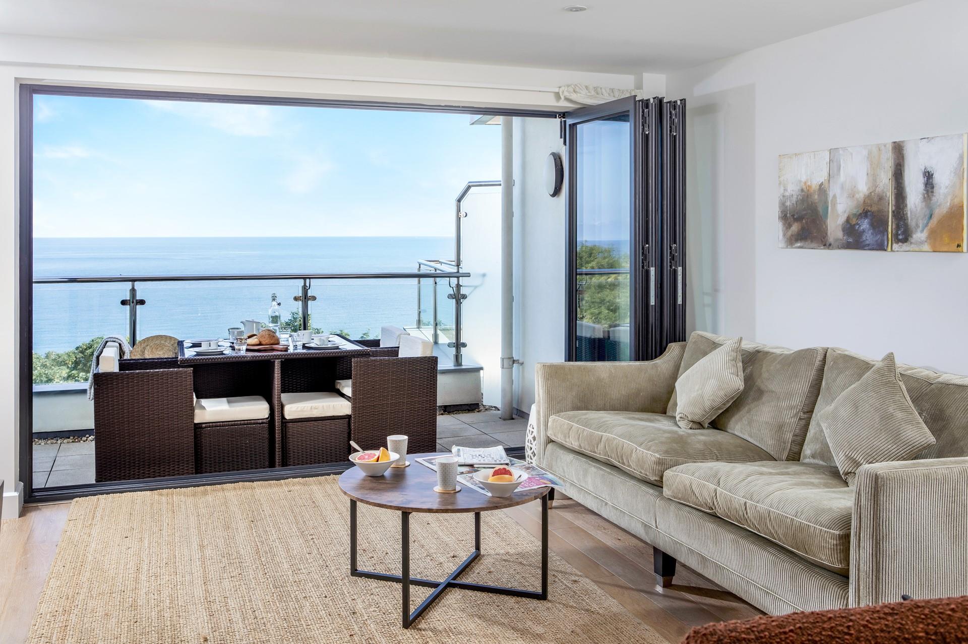 The sitting room has a stunning view across Porthminster and luxury furnishings.
