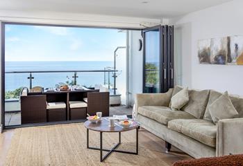 The sitting room has a stunning view across Porthminster and luxury furnishings.