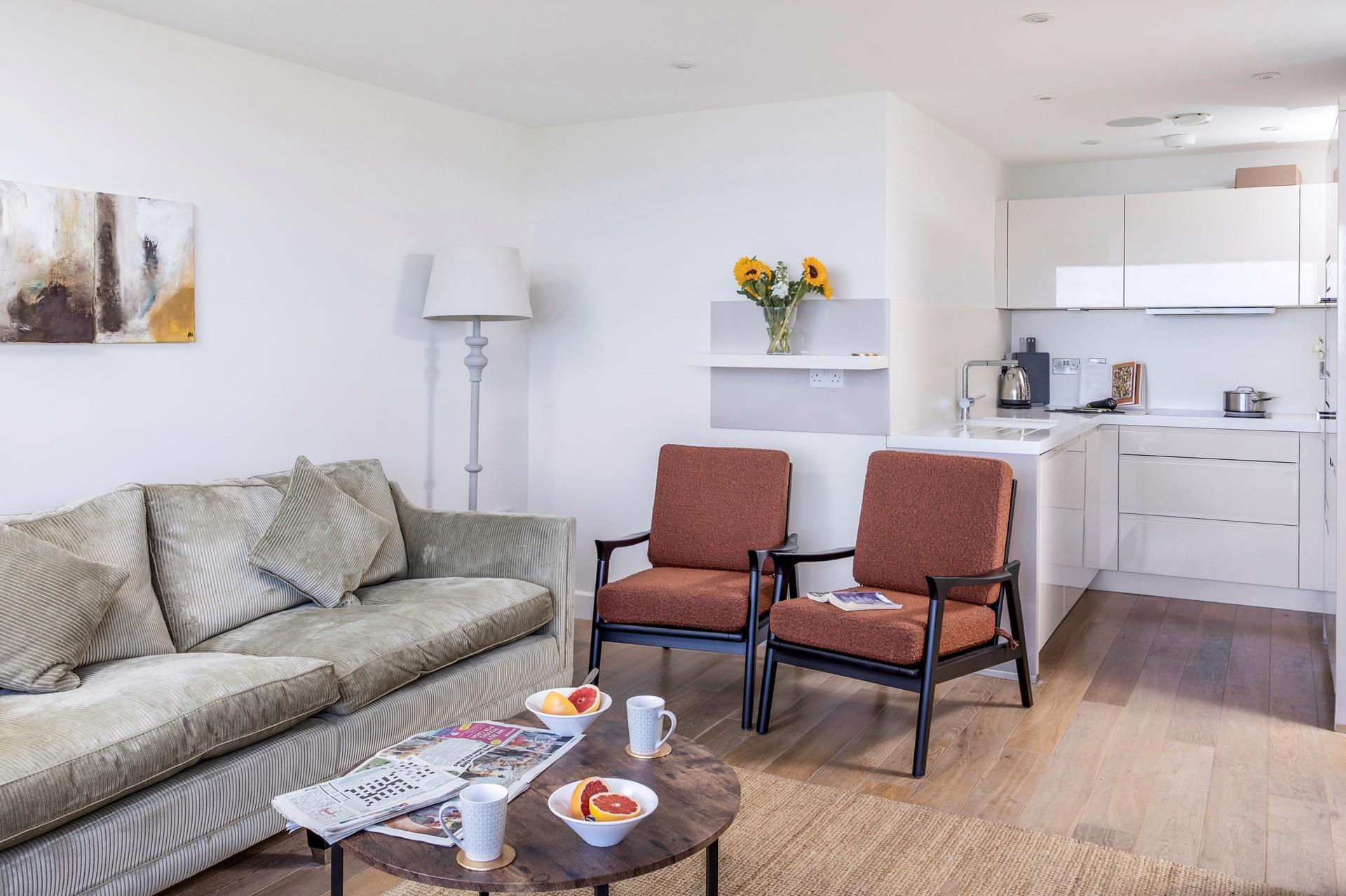 The open plan living space has cosy furnishings and stylish decor. 