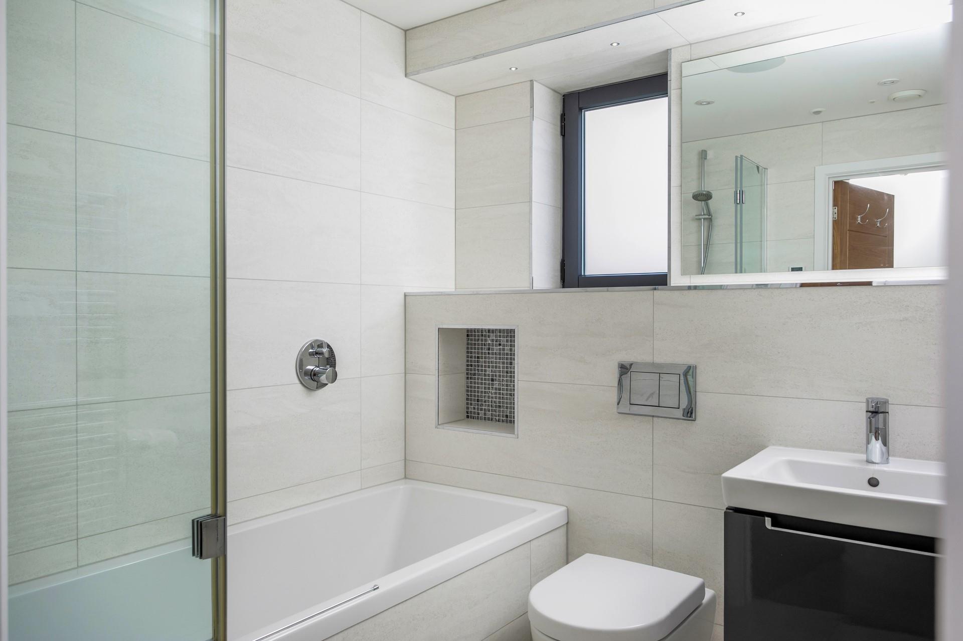 The family bathroom has automatic entry lighting and a well-sized bath.