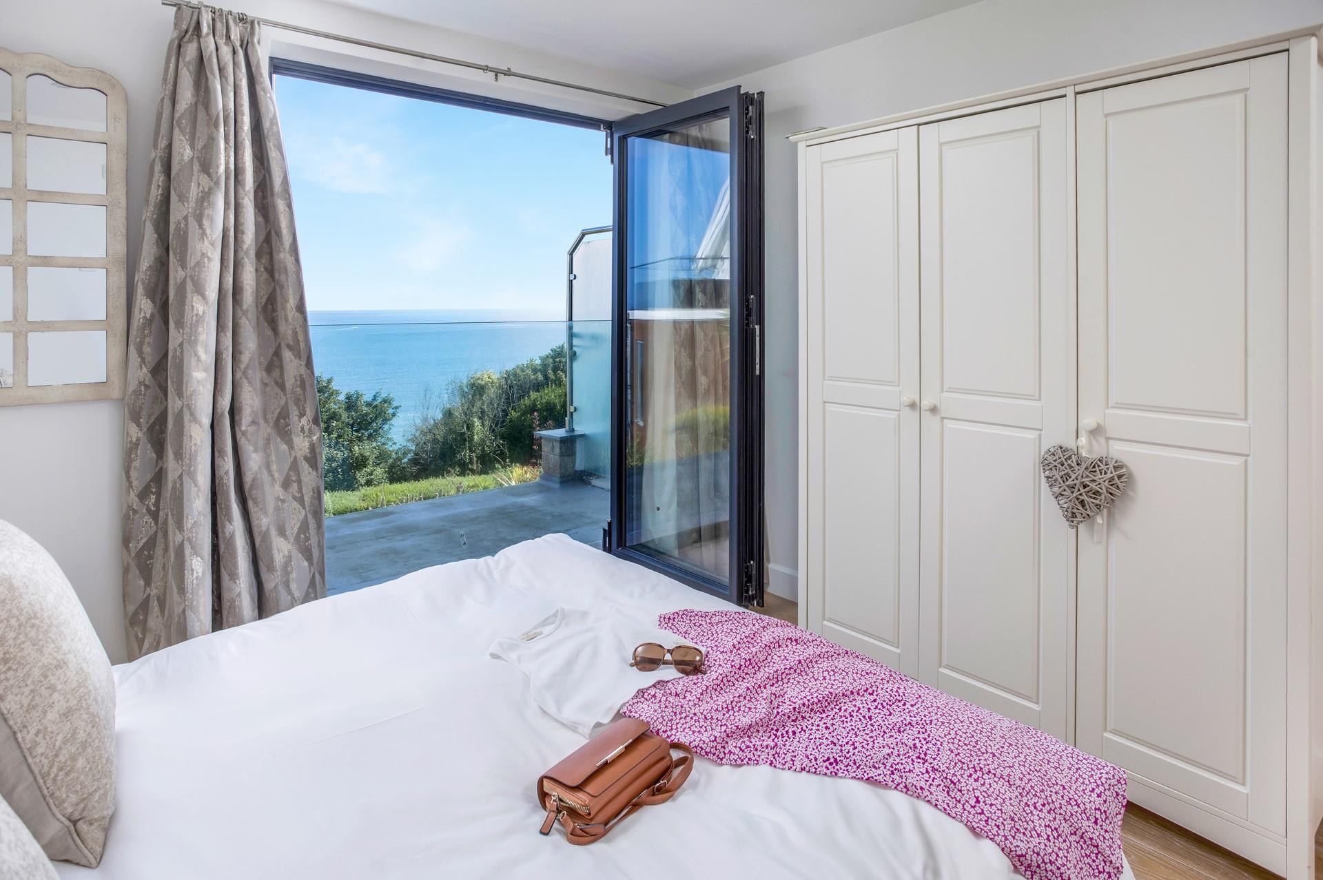 Bedroom 1 has a glass balcony which has a stunning uninterrupted sea view to wake up to each day.