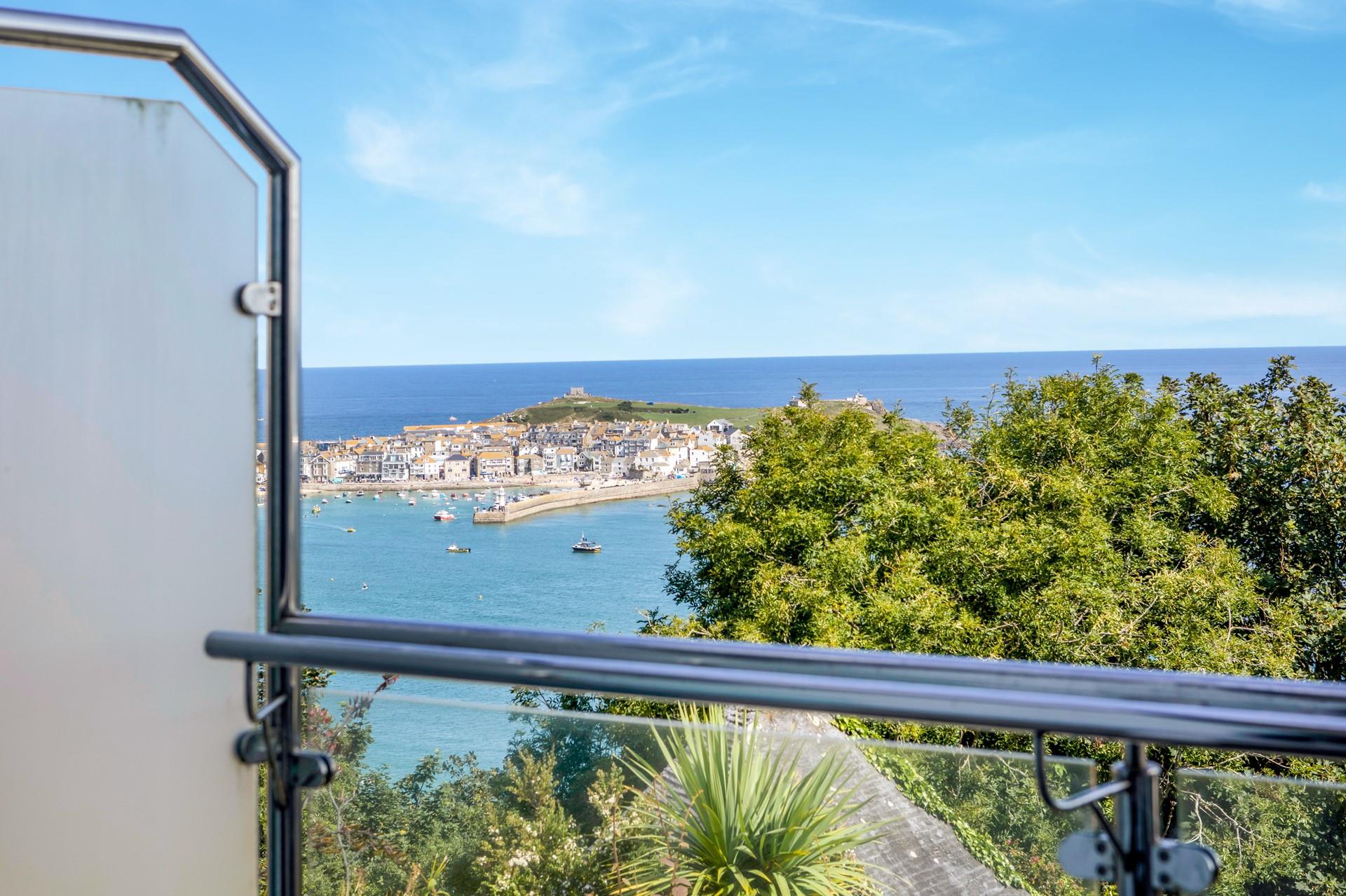 The private glass balcony is the perfect vantage point for the wonderful sea view.