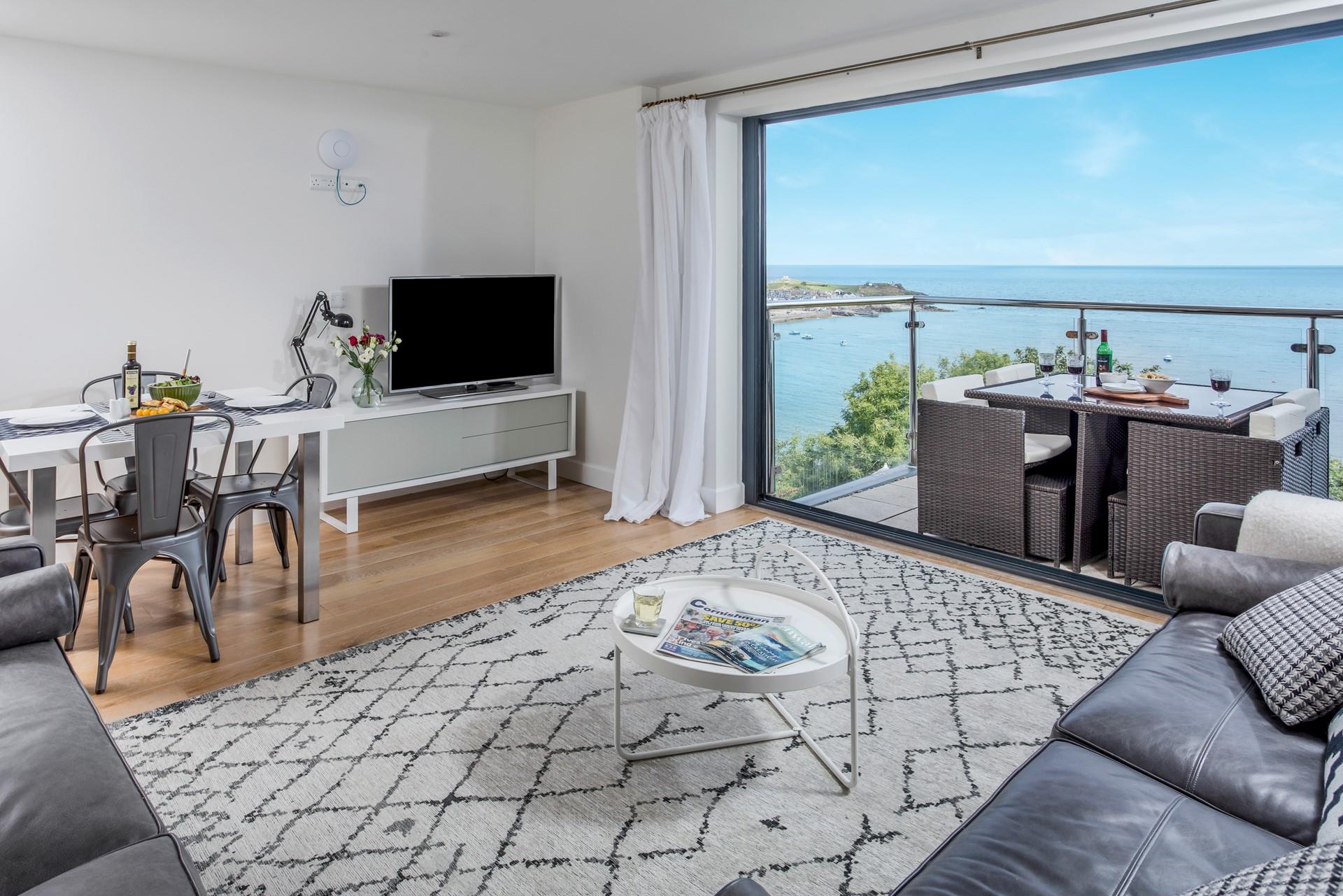 Open the balcony doors and enjoy a mix of indoor and outdoor living in the stylish apartment.