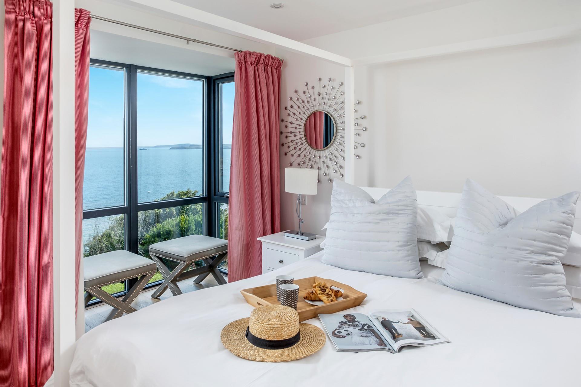 Plush pillows on the sumptuous king size bed await in bedroom 1.