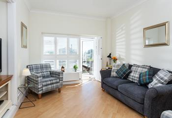 The welcoming open plan living space benefits from sea views.
