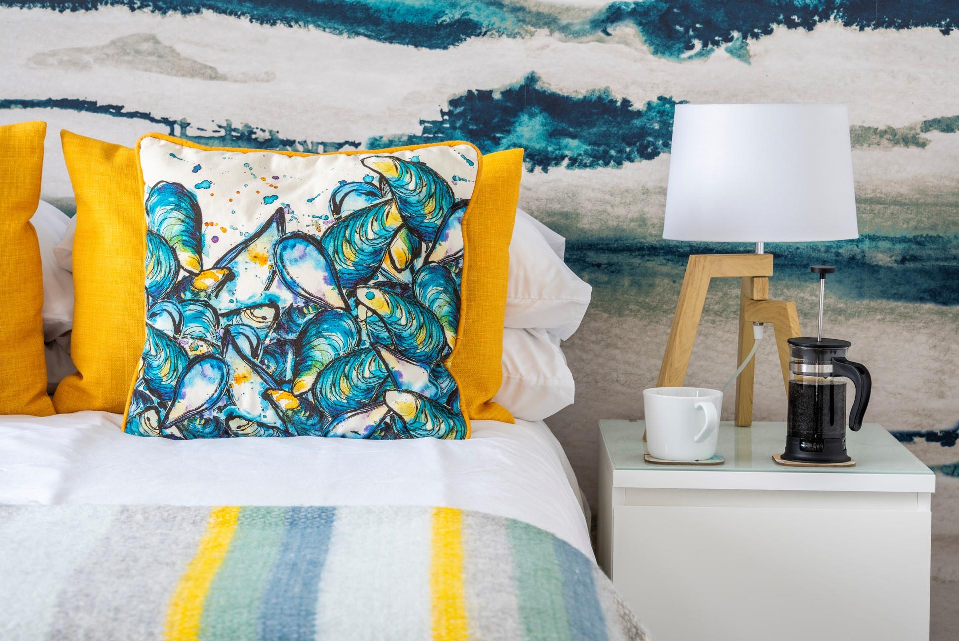 Eye-catching cushions adorn the bed.