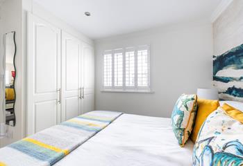 There's plenty of wardrobe space in this light and bright bedroom.